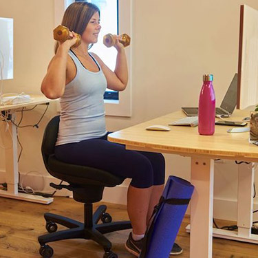 woman exercising at desk